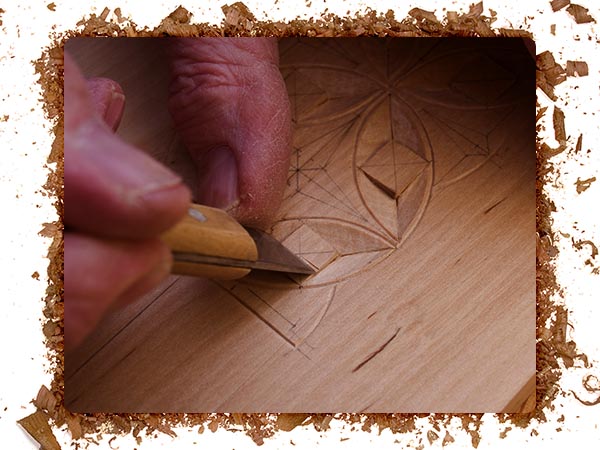 An image of a person using a wood carving tool to carve unique designs.